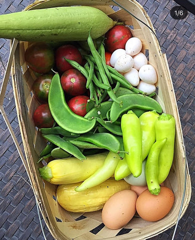 Basket full of vegetables and eggs