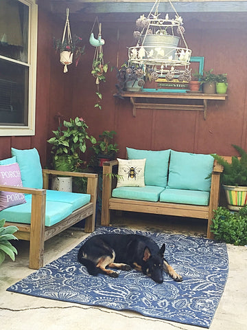 Cottagecore porch with sitting benches and dog laying on a rug