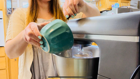 pouring dry ingredients into mixer