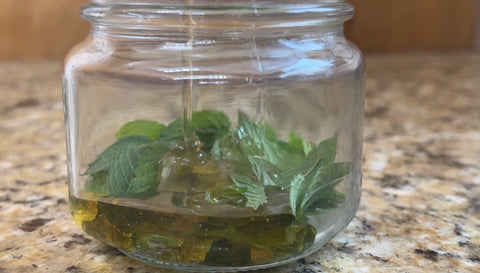 filling mint jar with honey