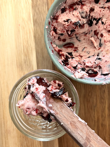 Putting blueberry honey butter in a jar