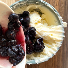 Mixing blueberries into butter