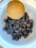 Adding lemon juice to blueberry sauce