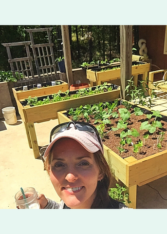 woman if front of raise bed garden