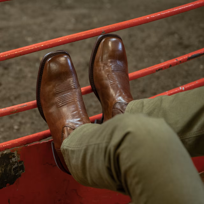 Man wearing The Doc square toe boots at a rodeo