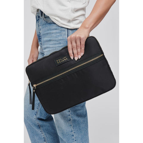 a model holding a black laptop sleeve with a gold zipper