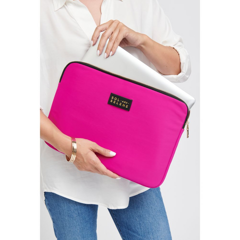 a model holding a bright pink laptop sleeve