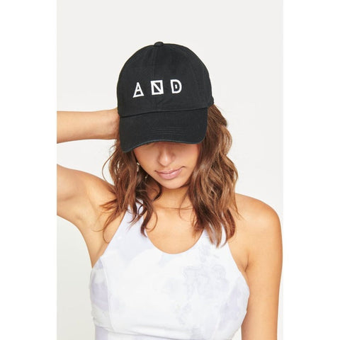 a model wearing a black baseball cap with Sol and Selene’s logo