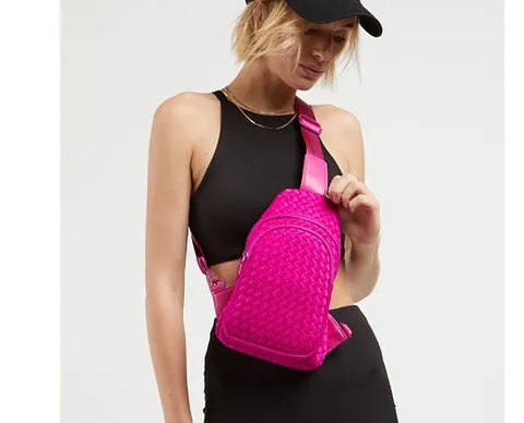 a model wearing a bright pink sling bag