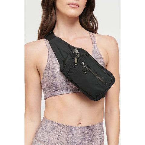 woman wearing a black belt bag across her chest