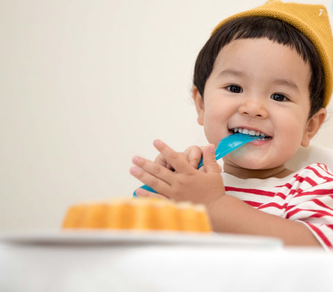 little boy eating smiling