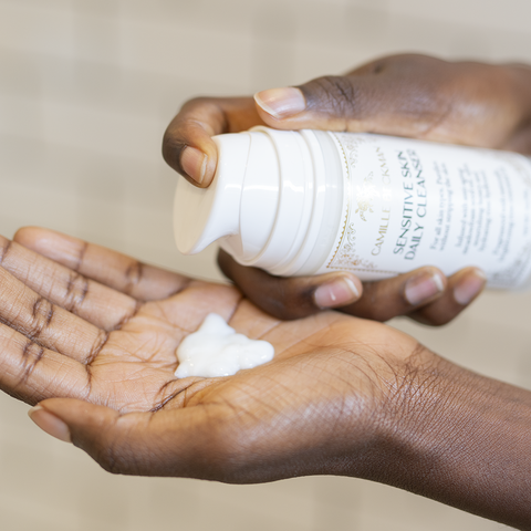 A product image shows a close-up of a woman's hands as she dispenses face cleanser