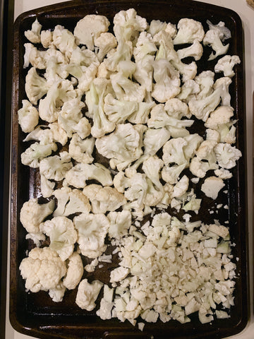 Cauliflower chopped on a baking sheet