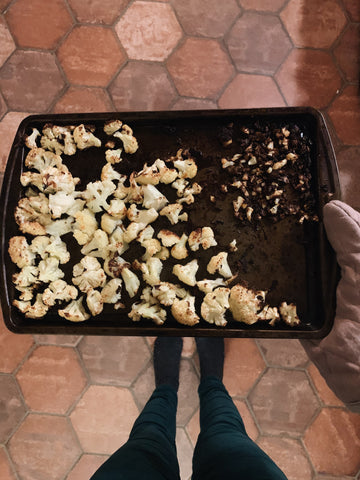 Cauliflower fully roasted on baking sheet