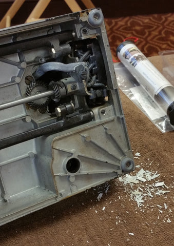 Cleaning off the lead oxidation on a Singer Featherweight 221 electrical tube under the machine.