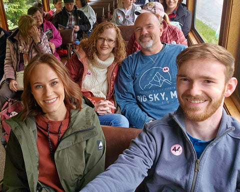 The Featherweight Shop staff aboard a Gold Rush-era train during a quilting cruise to Alaska in 2024.