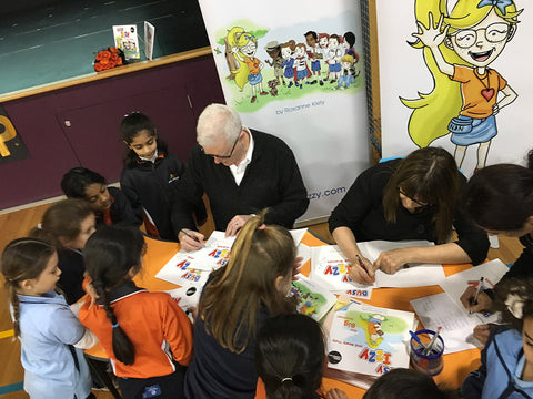 Stephen Kiely and Roxanne Kiely signing books for students at Amity College