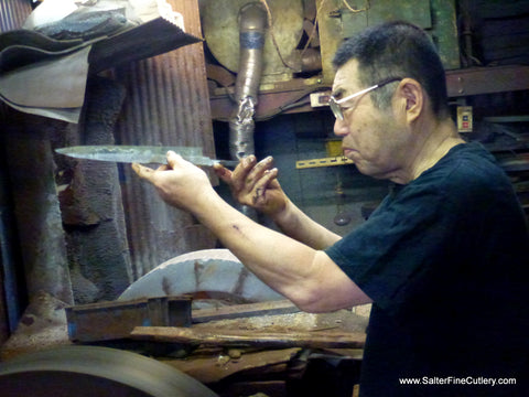 Master Japanese artisan grinding the edge of a chef knife for Salter Fine Cutlery