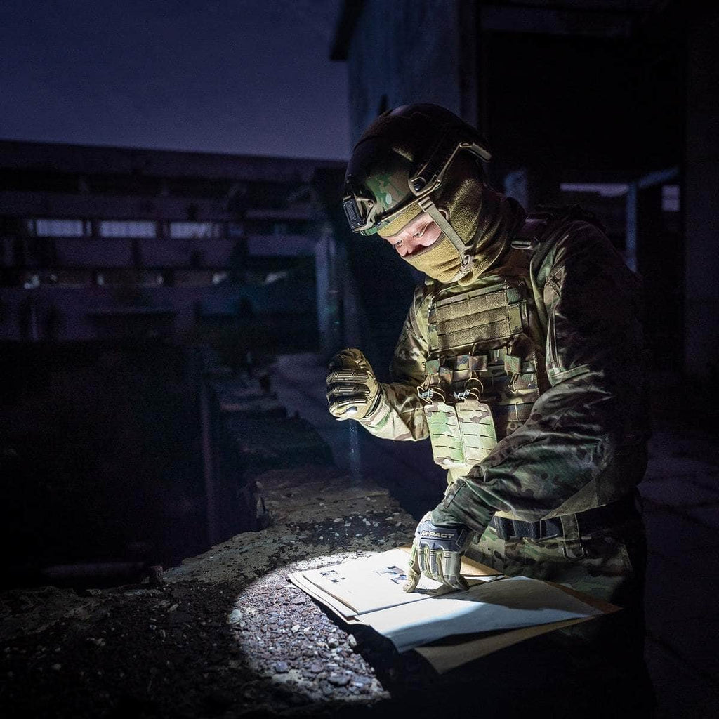 A soldier in tactical gear reviews a map by Weltool T1 Pro TAC at night.