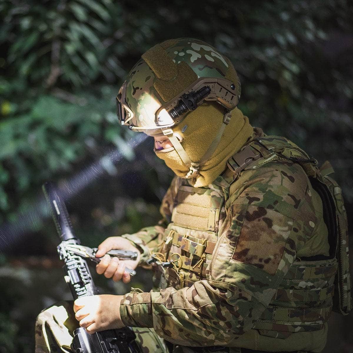 Soldier in camouflage gear inspecting a rifle, wearing a helmet with a mounted Weltool T1 Pro TAC mini tactical flashlight, surrounded by lush greenery with the Weltool T1 Pro TAC