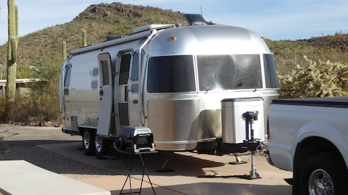 An Airstream travel trailer set up for a weekend of camping.