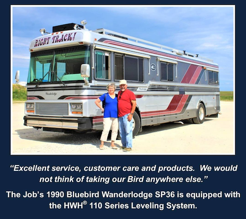 Photo courtesy of HWH Corporation. A happy couple in front of their 1990 Bluebird Wanderlodge with an HWH leveling system installed. 