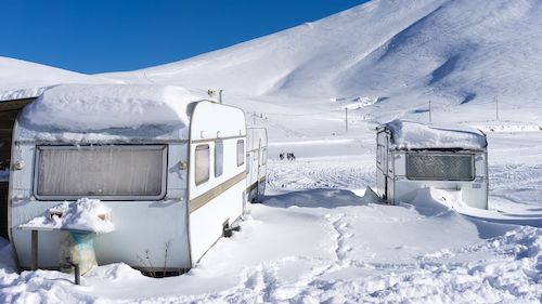 While outdoor storage may be less expensive than indoor, you will need to take extra precautions to winterize your RV.