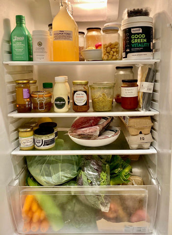 White plastic bottles on refrigerator