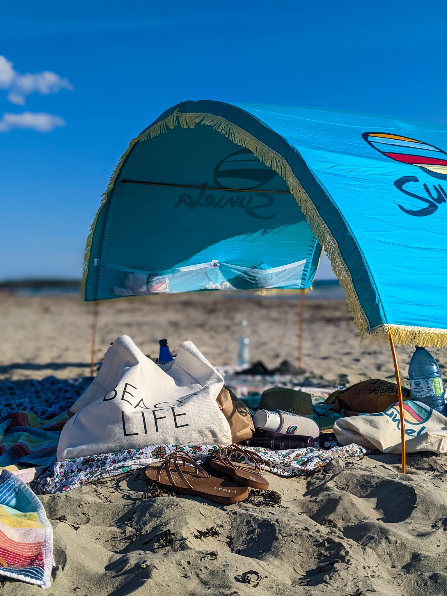 Suniela beach event set up for the Sandcastle Competition! Underneath the sun shade sits snacks, and beach accessories