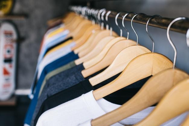 Clothes hanging on wooden hangers