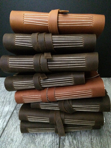 stack of handmade leather journals