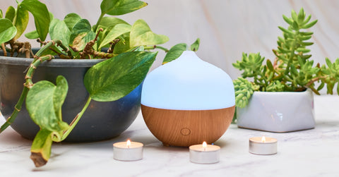 Aroma oil diffuser on table at home