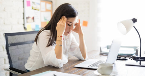 Businesswoman having headache at work