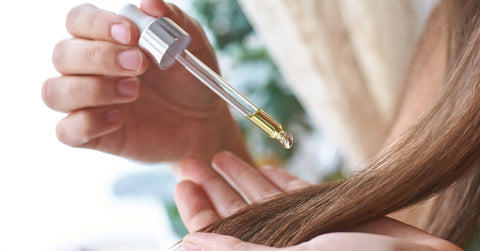 Girl Holding Dropper with Oil for Hair