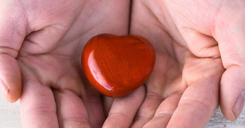 Hand Holding a Red Jasper Heart Shaped Crystal