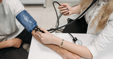 Healthcare Worker Measuring a Patient's Blood Pressure