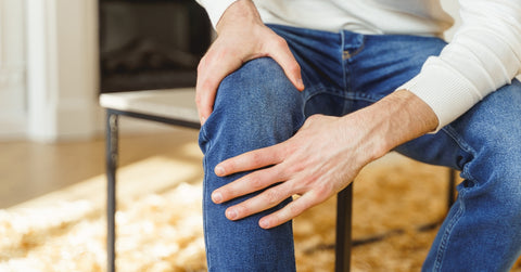 Male touching his inflamed knee