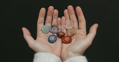 Person Holding Chakra stones