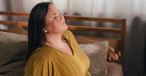 Woman Sitting on her Bed and Meditating