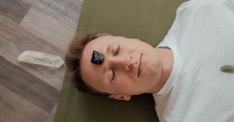 man with black tourmaline crystal in forehead