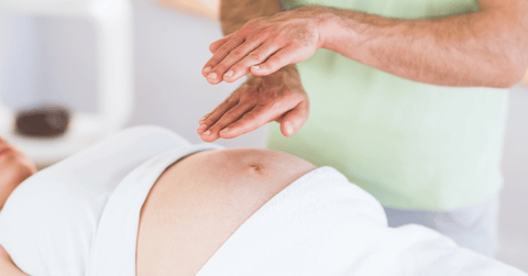 pregnant woman getting reiki treatment