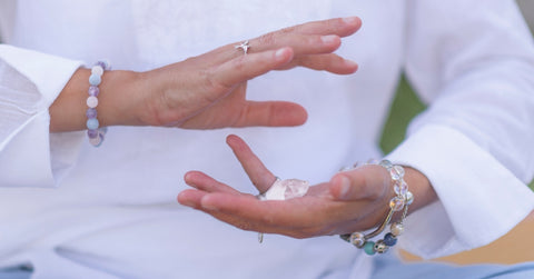 woman meditating with crystal