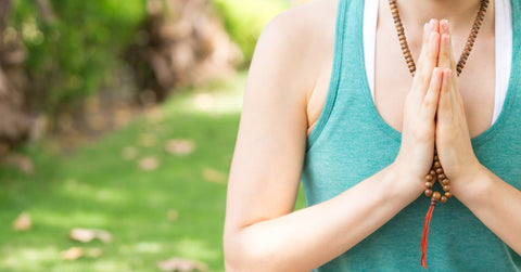 woman meditating with mala beads