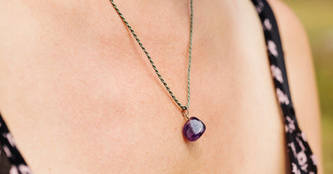 woman wearing amethyst pendant