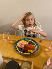 Family enjoying Valentine's Day dinner with treats and special glasses filled with sparkling apple cider