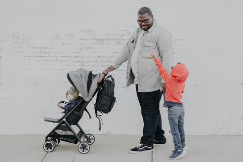 Dad with kids pushing stroller