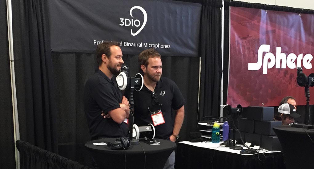 Image of two men standing inside the black 3Dio tradeshow booth.