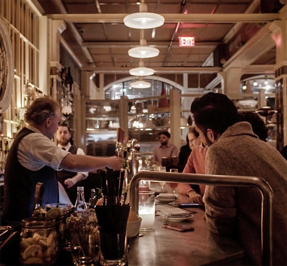 Image of a crowded, upscale bar in New York City.