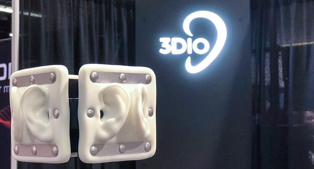 Image of a 3Dio Omni binaural microphone with a glowing 3Dio logo in the background.