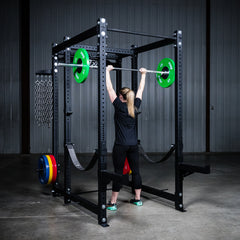Woman lifting weights using Build Limitless 6 Post Squat Rack